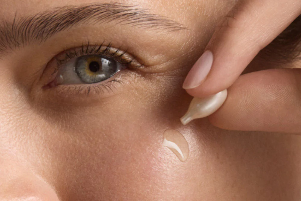 Close-up of a woman applying Retinol Correxion Line Smoothing Night Capsule to her face