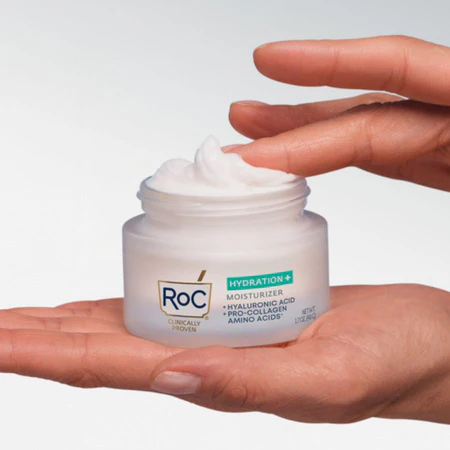 Hands holding a jar of Roc Hydration+ Moisturizers against a white background